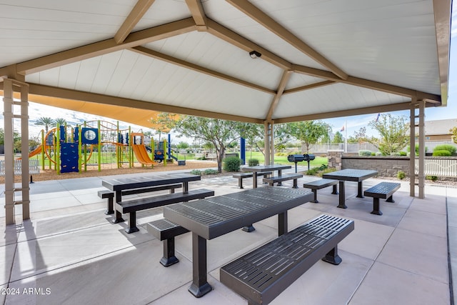 surrounding community featuring a playground, a gazebo, and a patio area