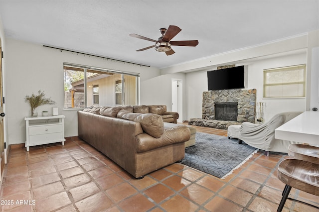 living room featuring ceiling fan and a fireplace