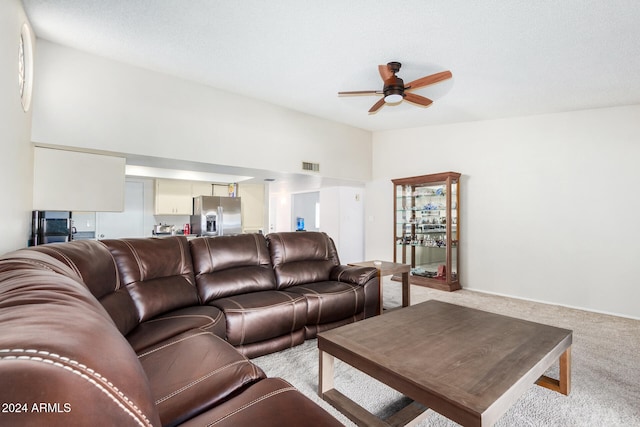 living room featuring light carpet and ceiling fan