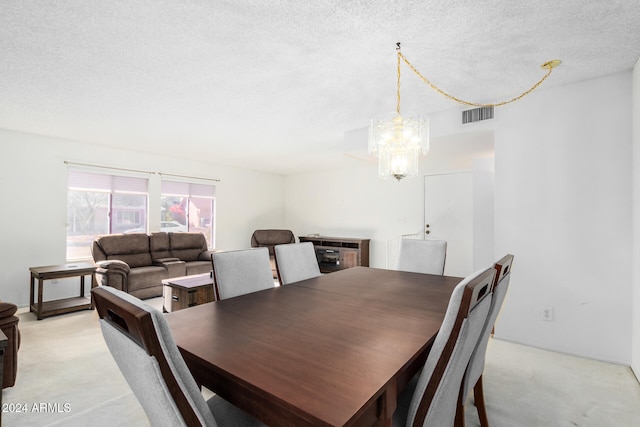 carpeted dining area featuring a textured ceiling and an inviting chandelier