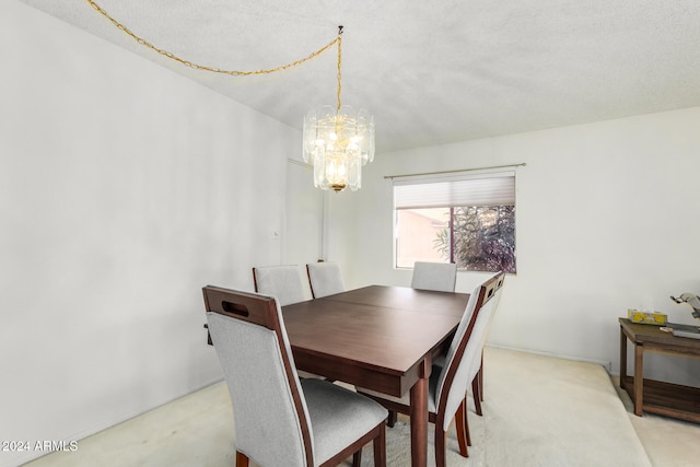 dining space with an inviting chandelier, light carpet, and a textured ceiling