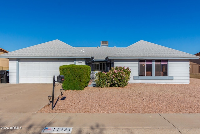 ranch-style home featuring a garage