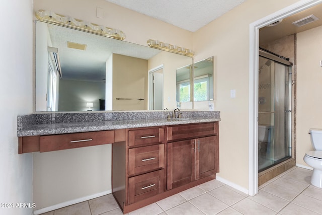 bathroom featuring walk in shower, tile patterned flooring, a textured ceiling, vanity, and toilet