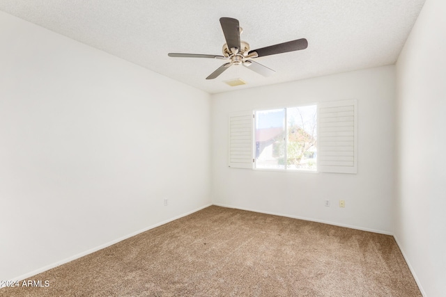 empty room with carpet, a textured ceiling, and ceiling fan