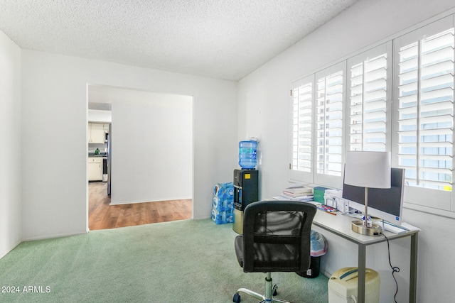 office area featuring a wealth of natural light, hardwood / wood-style floors, and a textured ceiling