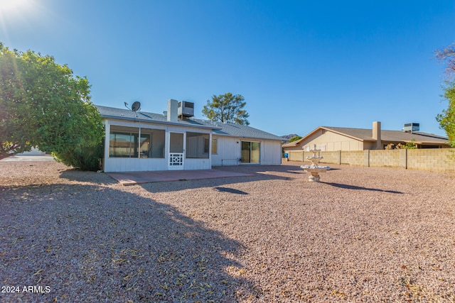 back of property with a patio