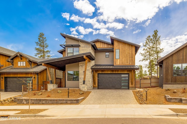 1809 E Magnolia Dr, Flagstaff, AZ 86005 - view of front facade with driveway, an attached garage, fence, and board and batten siding