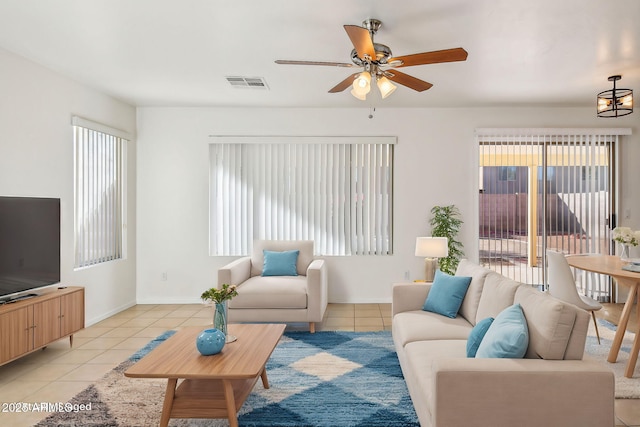 living room featuring light tile patterned floors and ceiling fan