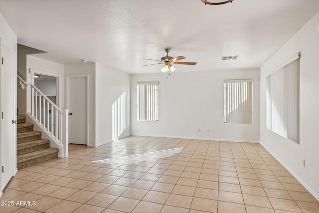 empty room featuring light tile patterned flooring and ceiling fan