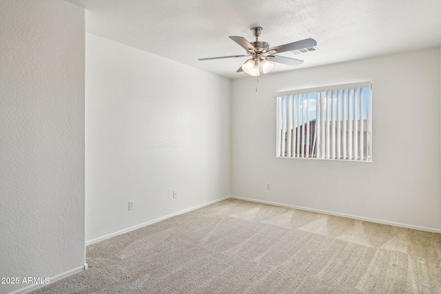 unfurnished room with light colored carpet and ceiling fan