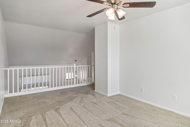 unfurnished room featuring vaulted ceiling, light colored carpet, and ceiling fan