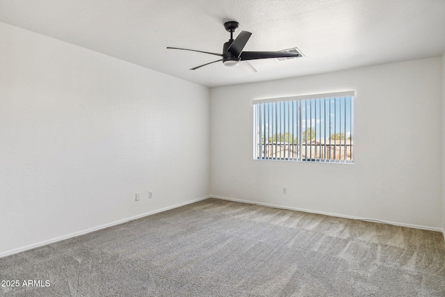 carpeted spare room with ceiling fan