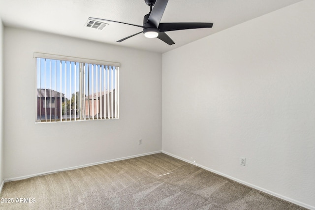 carpeted spare room featuring ceiling fan