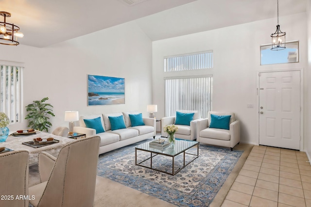 living room featuring light tile patterned floors and a notable chandelier