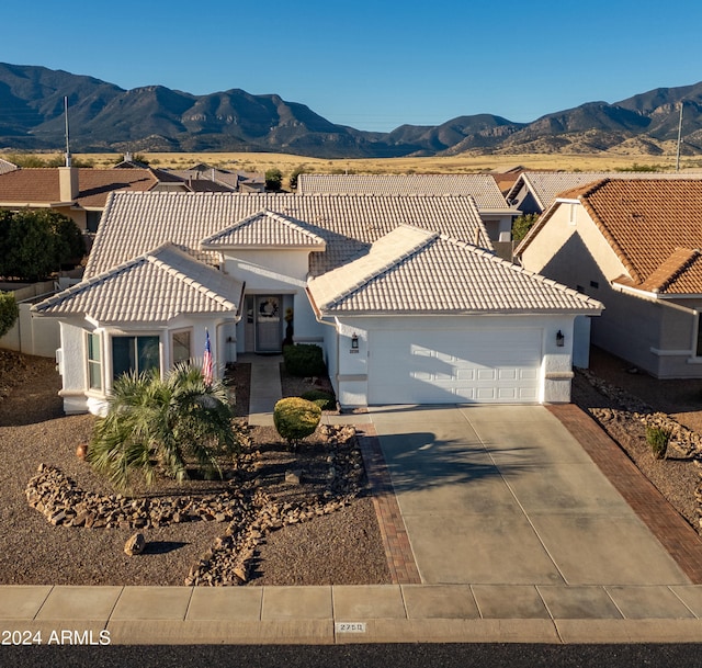 view of front facade featuring a mountain view and a garage