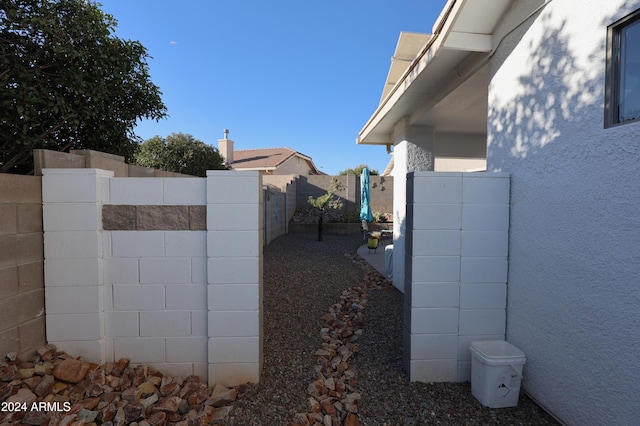 view of property exterior with fence and stucco siding
