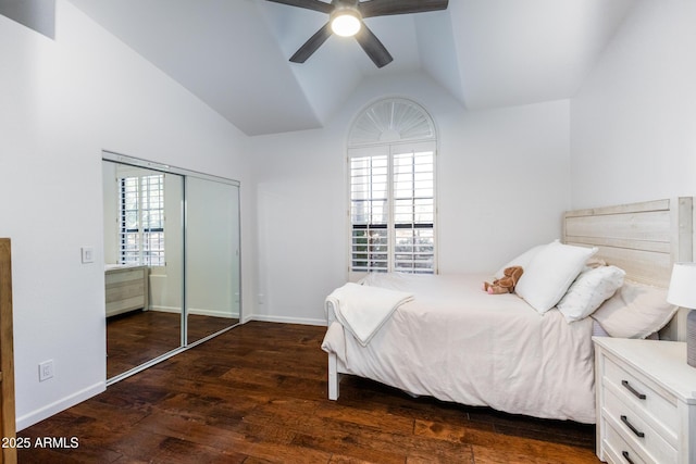 bedroom featuring ceiling fan, vaulted ceiling, multiple windows, and dark hardwood / wood-style floors