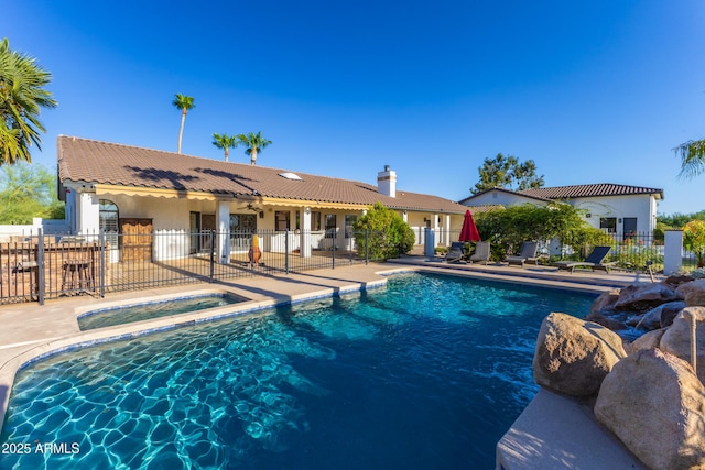 view of pool with a patio area and an in ground hot tub