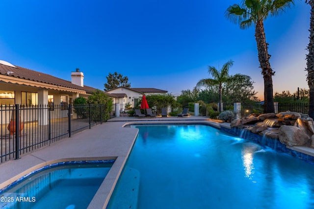 pool at dusk featuring a patio