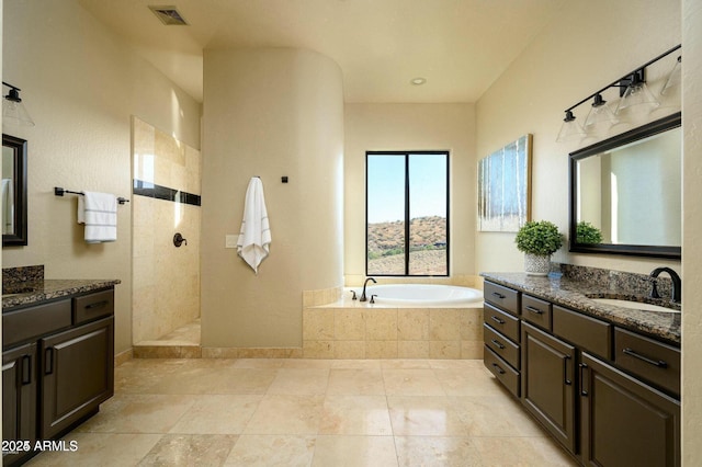 16569 E Trevino Dr, Fountain Hills, AZ 85268 - full bathroom featuring a garden tub, two vanities, a walk in shower, and tile patterned flooring