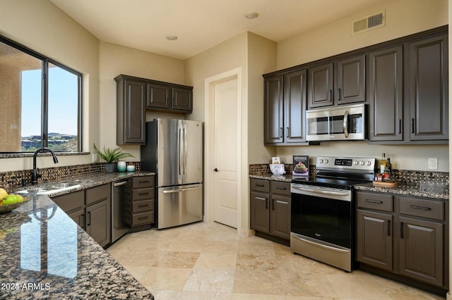16569 E Trevino Dr, Fountain Hills, AZ 85268 - kitchen with appliances with stainless steel finishes and dark stone countertops