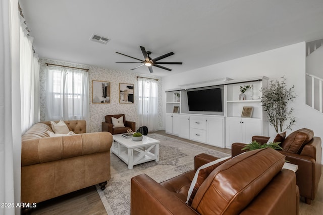 living room featuring ceiling fan and light hardwood / wood-style flooring