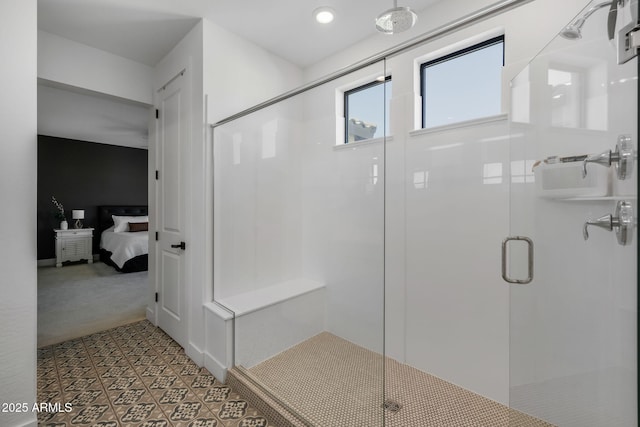 bathroom featuring a shower with shower door and tile patterned floors