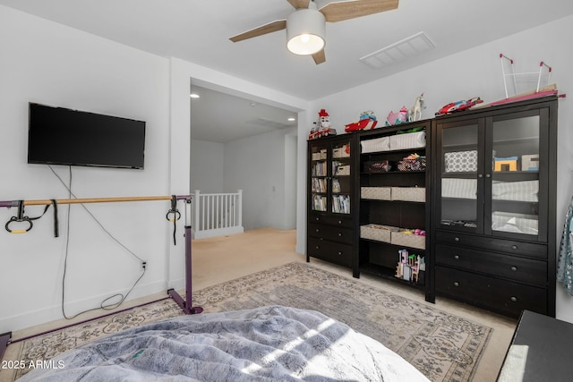 bedroom featuring light colored carpet and ceiling fan