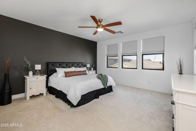 bedroom with light carpet and ceiling fan