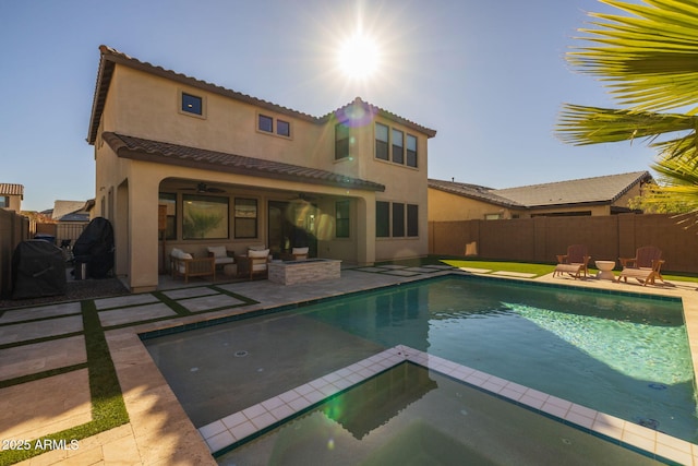 back of property with a patio area and a swimming pool with hot tub