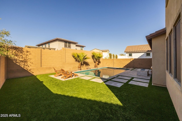 view of yard featuring a patio area and a fenced in pool