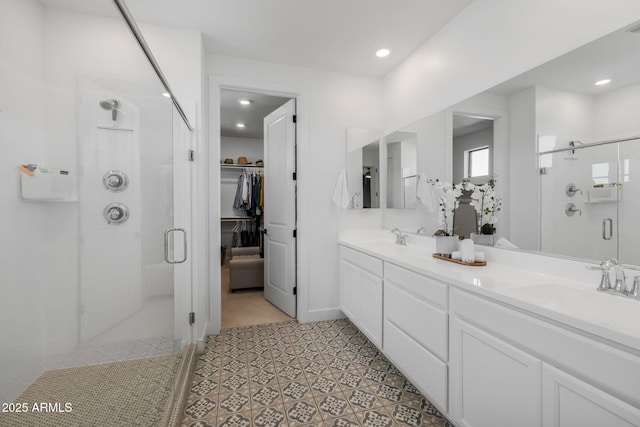 bathroom featuring tile patterned flooring, walk in shower, and vanity