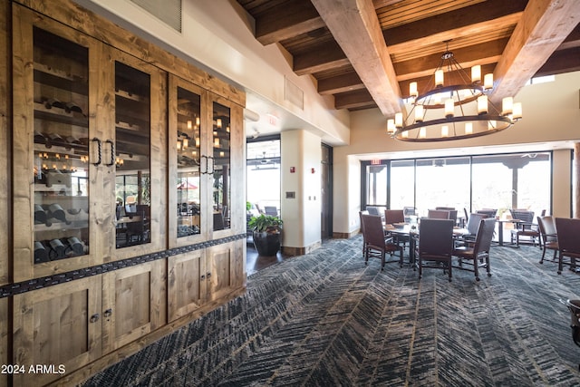 dining space featuring beamed ceiling and a chandelier