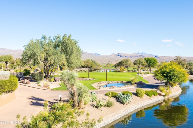 view of property's community with a yard and a water and mountain view