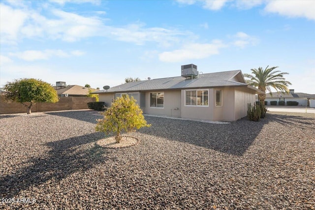 view of front of home with fence and central air condition unit