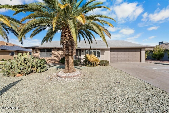 ranch-style home featuring concrete driveway and an attached garage