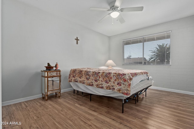 bedroom with ceiling fan and hardwood / wood-style flooring