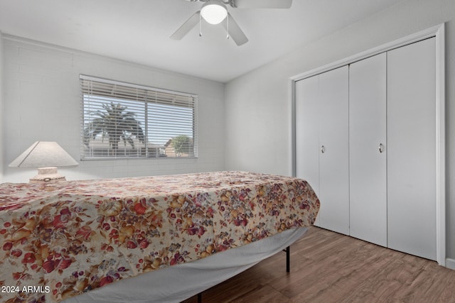 bedroom featuring ceiling fan, light wood-type flooring, and a closet