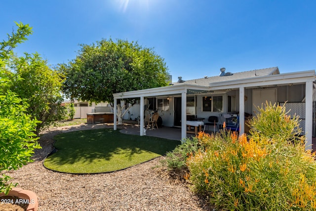 back of property featuring a yard and a patio