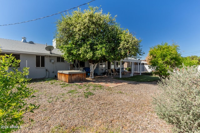 view of yard with a hot tub and a patio