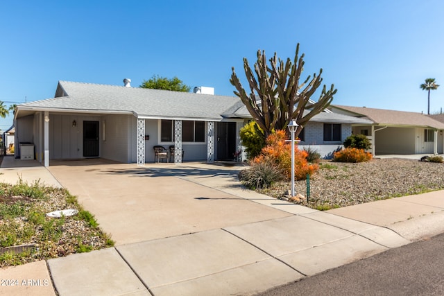 ranch-style home featuring a carport