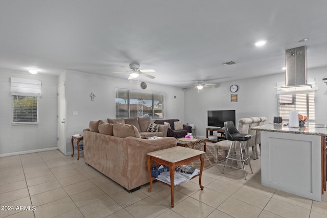 tiled living room with ceiling fan