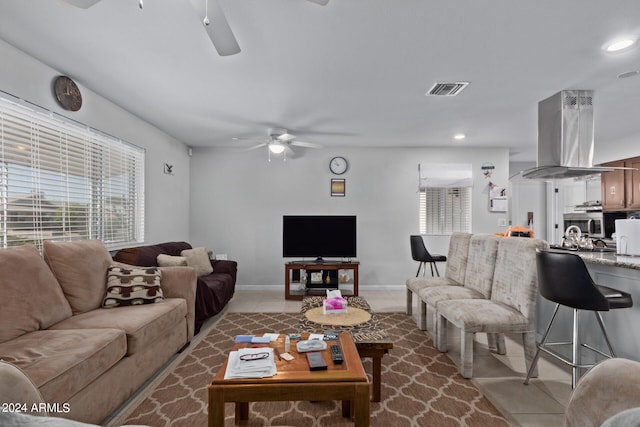 tiled living room featuring ceiling fan