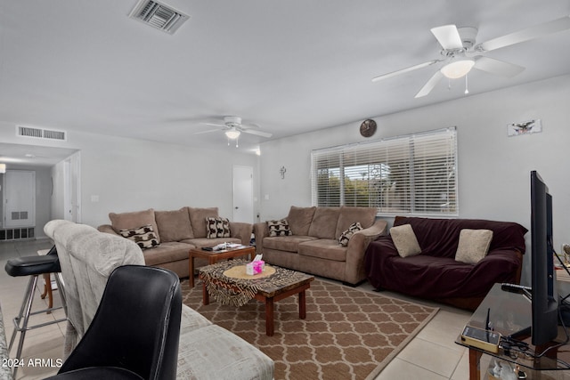 living room with light tile floors and ceiling fan