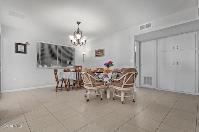 dining room with an inviting chandelier and light tile flooring