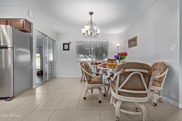 tiled dining area with an inviting chandelier