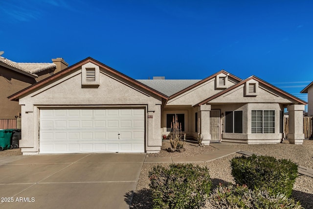 ranch-style home with driveway, a chimney, an attached garage, and stucco siding