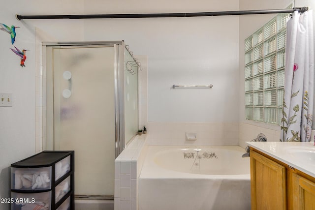 bathroom with vanity, a shower stall, and a bath