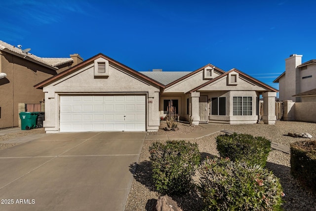 ranch-style home with driveway, a garage, and stucco siding