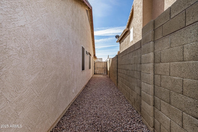 view of home's exterior featuring fence and stucco siding